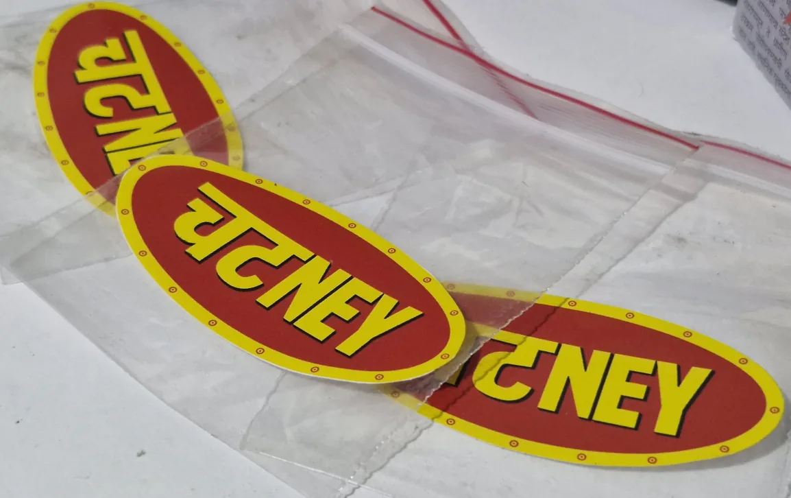 Close up of three chutney sachets, their “चटNEY” labels overlapping.