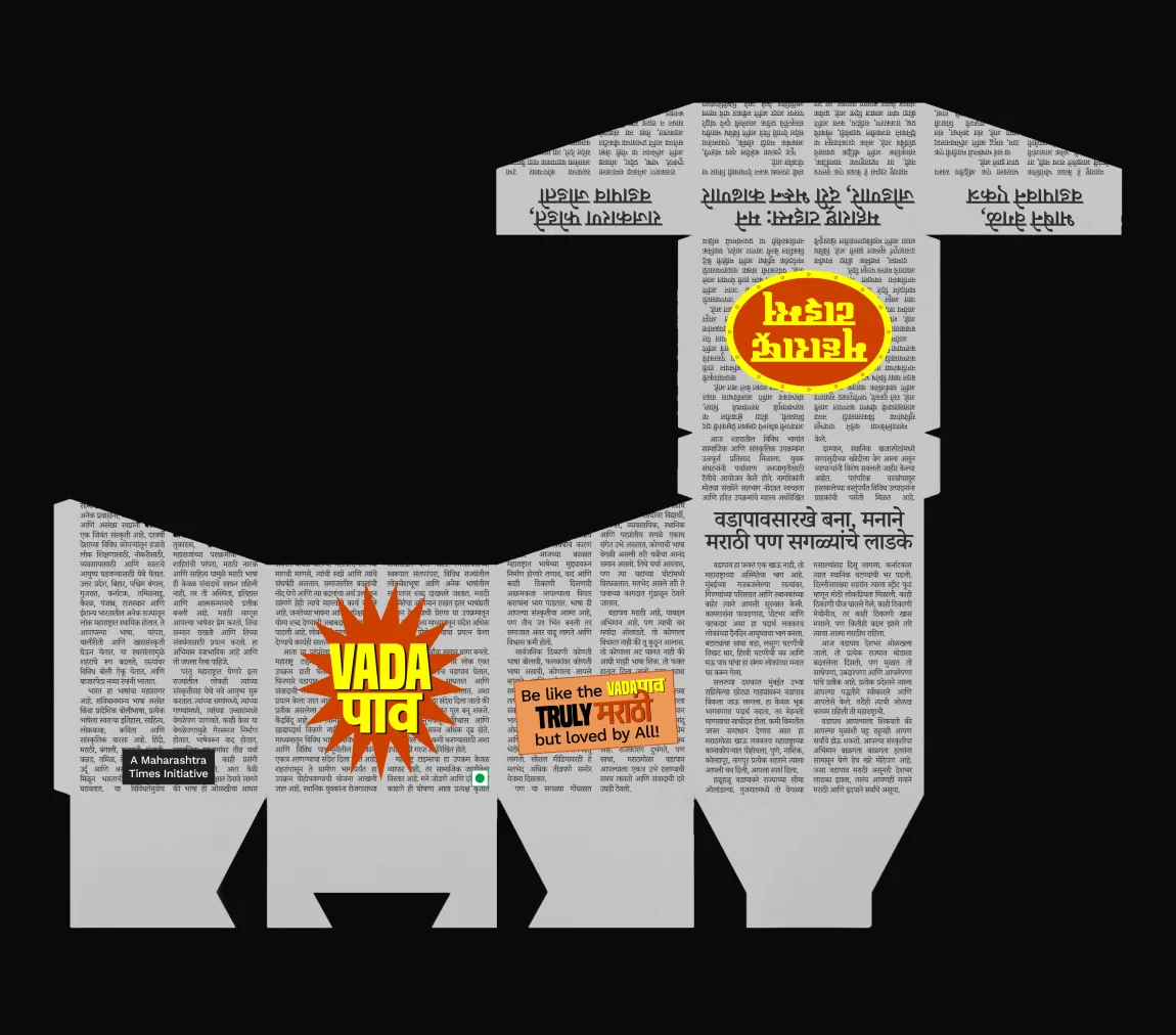 The box’s dieline laid flat on black: newspaper columns, the “VADA पाव” starburst and the flaps.